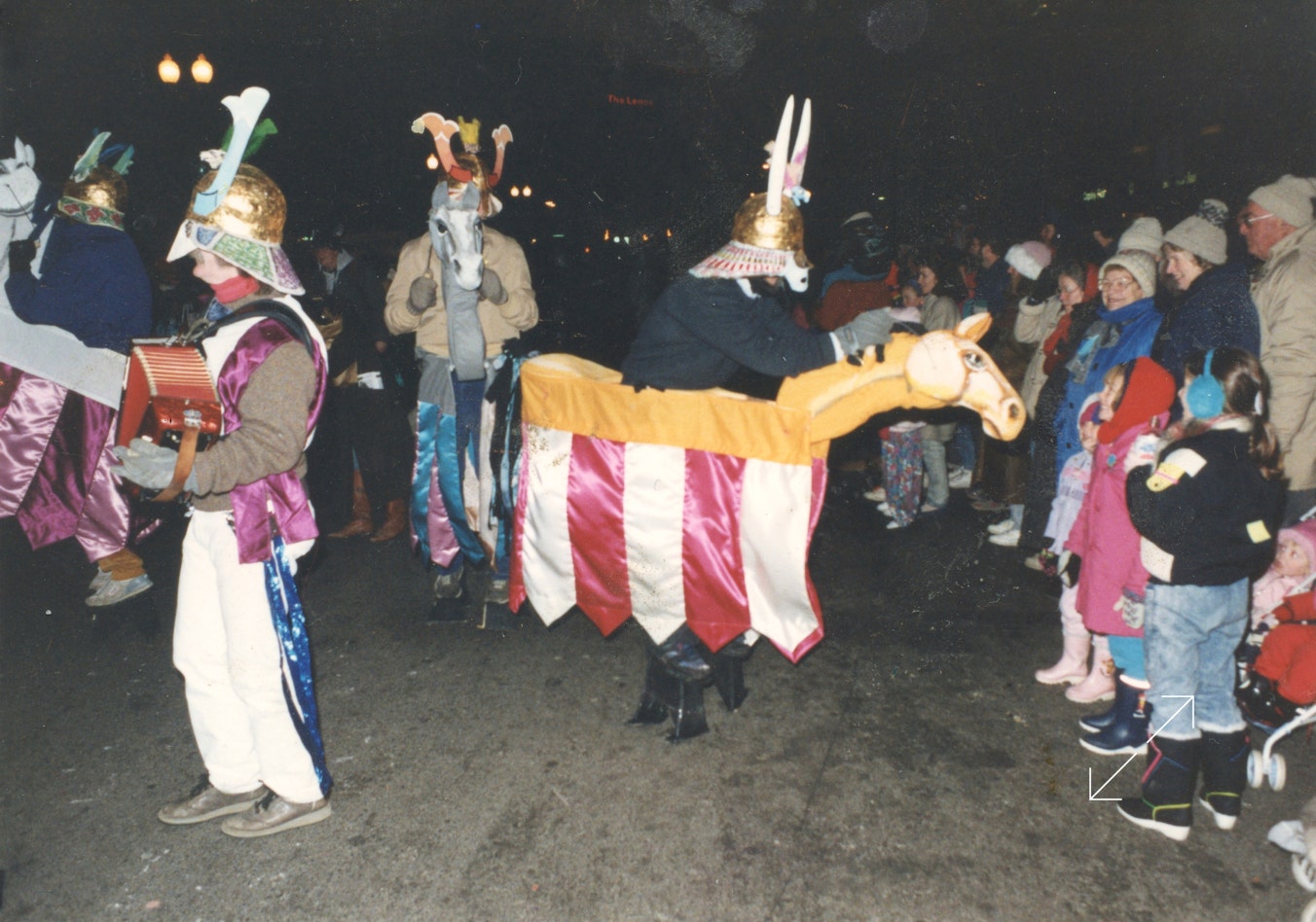 Ryan Thomson playing his accordion while "Samurai Warriors" prance around him on hobby horses during the 1996 Boston First Night Parade