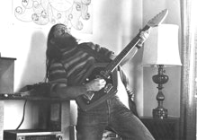 Ryan Thomson posing with his Vox electric guitar