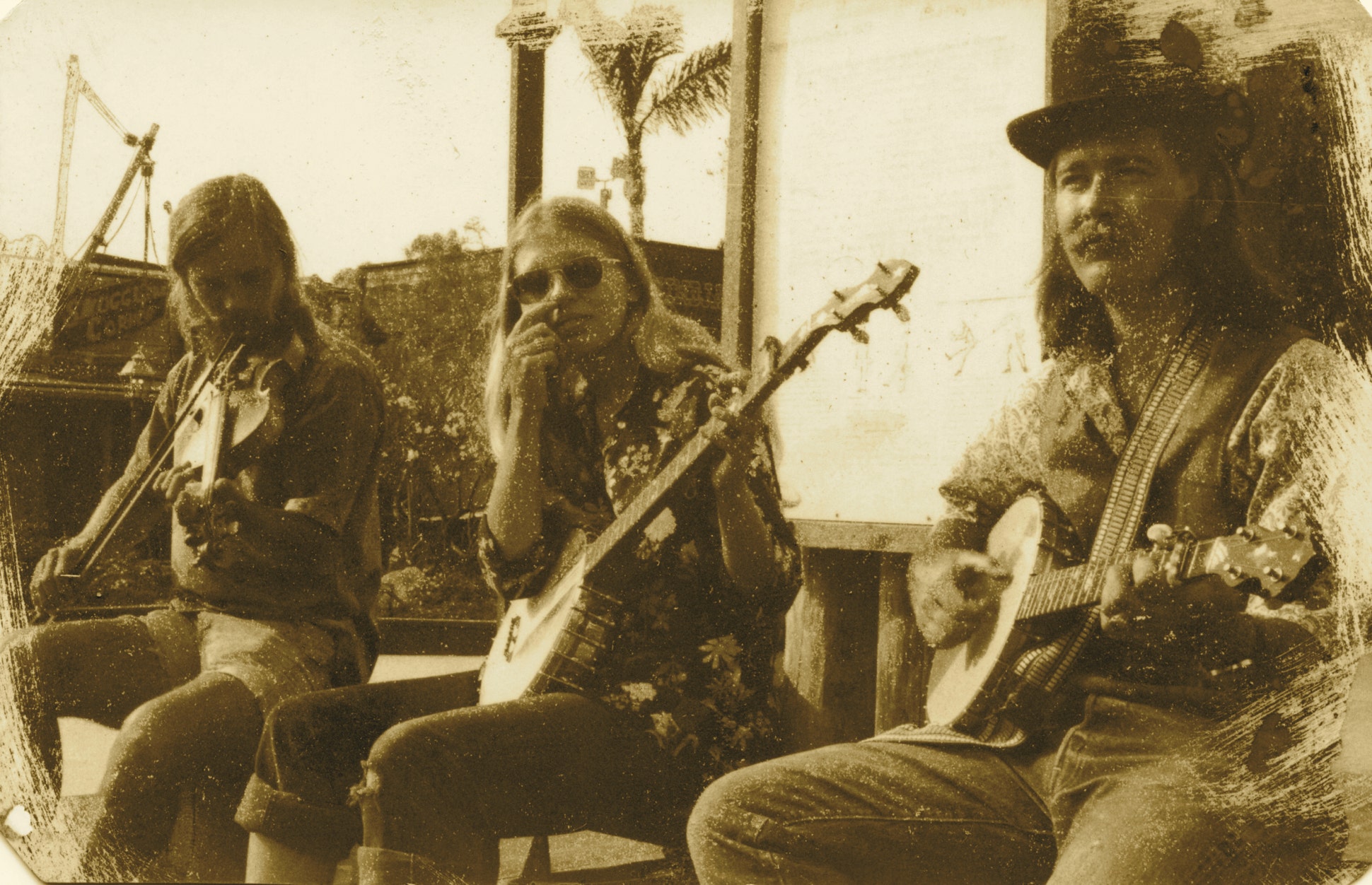Chicken Cheek Tweakers old time string band, on stage in Old Town State Park, San Diego, California, Dave Brown on fiddle, Pam Ostergren and Ryan Thomson playing banjos, 1975.