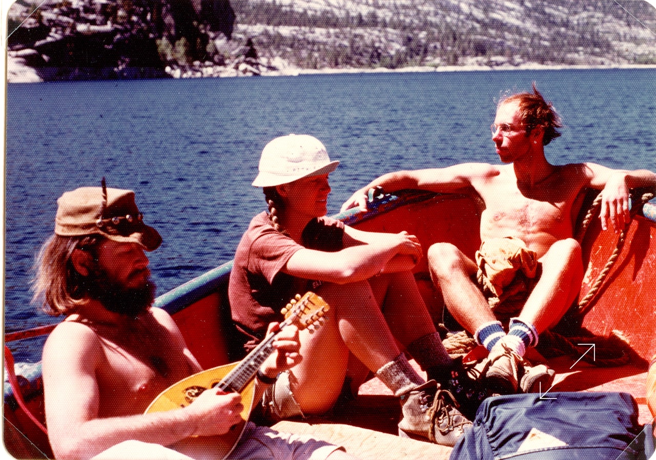 Photo of Ryan Thomson playing mandolin in the Sierra mountains in 1978 on a back packing trip with friends.