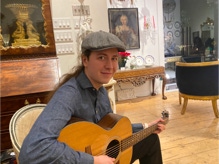 Brennish Thomson performs on guitar at fine arts gallery in Essex, Massachusetts