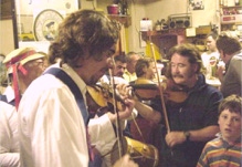 Ryan Thomson fiddles at a Comhaltas session in a pub in Rossport, Ireland,  along with a band mate from their Morris tour