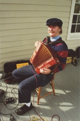 Ryan Thomson performs on accordion in Greenwich, Connecticut